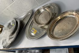 Fourteen assorted stainless steel oval plates (may show signs of long term storage).