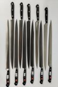 Eleven Wusthof narrow slicer bolstered knives, 320mm (4520) (over 18s only).
