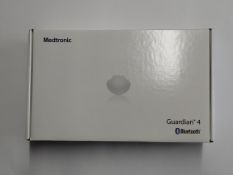 An as new Medtronic Guardian 4 Transmitter Kit (REF: MMT-7840W1, Recharge By Date: 2025-03-24).