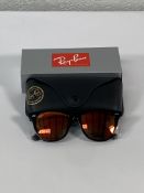 A pair of Ray-Bans Wayfarer Flash sunglasses in black with grey mirror orange lenses (RB2140 901-69)
