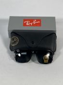 A pair of Ray-Bans Wayfarer sunglasses in black and G-15 green classic lenses (RB4347).