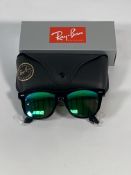 A pair of Ray-Bans Wayfarer Flash sunglasses in black with green mirror lenses (RB2140 901-19).