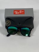 A pair of Ray-Bans Wayfarer Flash sunglasses in black with green mirror lenses (RB2140 901-19).