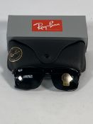 A pair of Ray-Bans Wayfarer sunglasses in black and G-15 green classic lenses (RB4347).