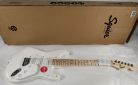An as new Fender Squier Sonic Stratocaster, HT MN WPG AWT electric guitar in white, white pick guard
