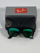 A pair of Ray-Bans Wayfarer Flash sunglasses in black with green mirror lenses (RB2140 901-19).