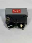 A pair of Ray-Bans Square sunglasses in polished gold and black with G-15 green classic lenses (RB48