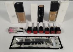 Eleven assorted tester Dior items - foundations/lipsticks and lip gloss.