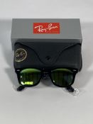 A pair of Ray-Bans Wayfarer Flash sunglasses in black with yellow mirror lenses (RB2140 901-18).