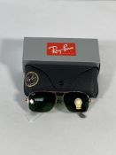 A pair of Ray-Bans Square sunglasses in polished gold and black with G-15 green classic lenses (RB48