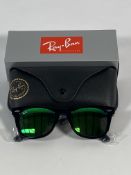 A pair of Ray-Bans Wayfarer Flash sunglasses in black with green mirror lenses (RB2140 901-19).