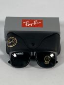 A pair of Ray-Bans Justin Classic sunglasses in black with G-15 green classic lenses (RB4165).