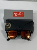 A pair of Ray-Bans Wayfarer Flash sunglasses in black with grey mirror orange lenses (RB2140 901-69)