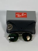A pair of Ray-Bans Pilot sunglasses in polished gold and G-15 green lenses (RB4648).