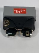 A pair of Ray-Bans Pillow sunglasses in polished gold with G-15 green classic lenses (RB3706).