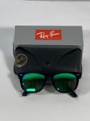 A pair of Ray-Bans Wayfarer Flash sunglasses in black with green mirror lenses (RB2140 901-19).