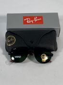 A pair of Ray-Bans Square sunglasses in black and red with G-15 green classic lenses (RB6102).