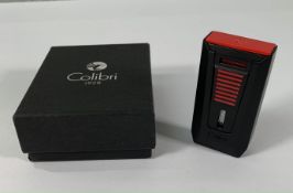 An as new Colibri Slide Double Jet Flame cigar lighter with Punch Cutter matte black/red (box unseal