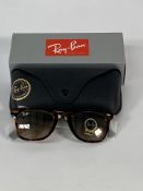 A pair of Ray-Bans Wayfarer Classics sunglasses in tortoise and light brown lenses (RB2140).