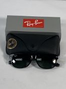 A pair of Ray-Bans Wayfarer sunglasses in black with green classic lenses (RB2132).