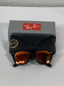 A pair of Ray-Bans Wayfarer Flash sunglasses in black with grey mirror orange lenses (RB2140 901-69)