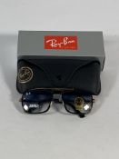 A pair of Ray-Bans Square sunglasses in polished gold and black with G-15 blue gradient lenses (RB44