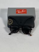 A pair of Ray-Bans Round sunglasses in tortoise with brown lenses (RB4222).