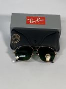 A pair of Ray-Bans Pilot sunglasses in polished gold and G-15 green lenses (RB4648).