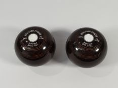 A pair of Drakes Pride Richmond Crown Green Bowls, Brown.