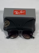 A pair of Ray-Bans Erika Classic sunglasses in matte rubber black and light grey gradient lenses (RB