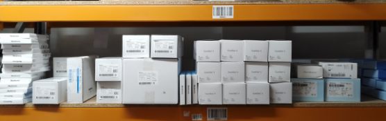 A large quantity of assorted Medtronic items on one shelf.