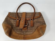 A pre-owned Coach handbag.