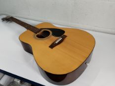 A pre-owned Yamaha F-310 acoustic guitar.