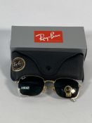 A pair of Ray-Bans Pillow sunglasses in polished gold with G-15 green classic lenses (RB3706).