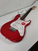 An as new Squier Mini Stratocaster, Dakota Red.