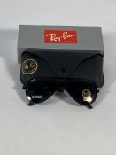 A pair of Ray-Bans Aviator sunglasses in red and black with G-15 green classic lenses (RB6104).