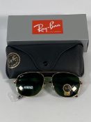 A pair of Ray-Bans Pilot sunglasses in polished gold and G-15 green lenses (RB4648).