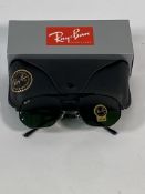 A pair of Ray-Bans Irregular sunglasses in polished black with G-15 green classic lenses (RB3707).