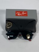 A pair of Ray-Bans Square sunglasses in black and red with green classic lenses (RB4858).