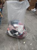 A bag of as new clothing and related items.