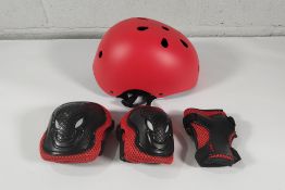 A large amount of XJD Kids Helmets with elbow/knee pads and wrist guards, various sizes and colours.