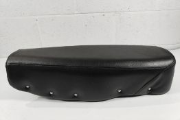 A re-upholstered seat for a classic motorcycle, black with studs on edging, unknown fitment.