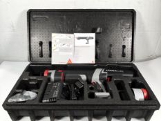 A Sika PowerCure 400 adhesive dispenser with battery, charger and instructions (outer packaging open