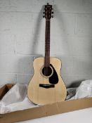 A Yamaha F310 acoustic guitar with some minor damage.