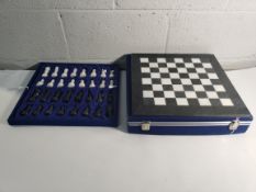 An unbranded marble style chess set in a case (sold as seen).