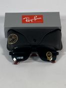 A pair of Ray-Bans Square sunglasses in black and red with green classic lenses (RB4858).