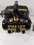 A Stanley FATMAX 6ltr DST 101/8/6 silent portable air compressor.