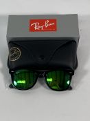A pair of Ray-Bans Wayfarer Flash sunglasses in black with green mirror lenses (RB2140 901-19).