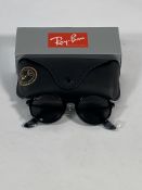 A pair of Ray-Bans Round sunglasses in black and grey lenses (RB4222).