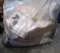 A large bag of assorted as new clothing with tags.
